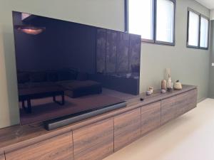 a large flat screen tv in a living room at Villa Terracotta - 11pers 24h du Mans - Rêve au Mans in Le Mans