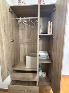 a walk in closet with wooden walls and shelves at Arusticana al 393 in Catania