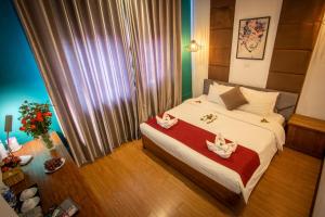 Postel nebo postele na pokoji v ubytování NT Elysian hotel