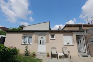 a house with two chairs and a white door at Rooms Butković in Zagreb