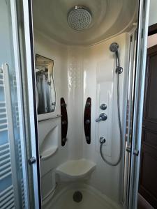 Un pequeño baño con inodoro y ducha. en Esprit Londonien - WIFI - TV -, en Bracquemont