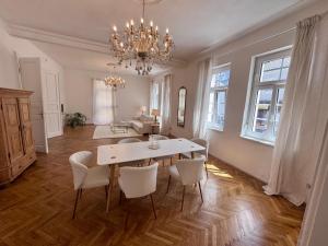 a dining room with a white table and chairs at Charmante Wohnung in Ferlach in Ferlach