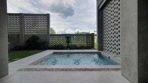 a swimming pool in the middle of a yard at Dylan's Hot Spring in Los Baños