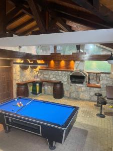 a pool table in a room with a fireplace at Guest House Colovic in Zlatibor