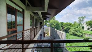 a balcony of a house with a view of a yard at Dylan's Hot Spring in Los Baños