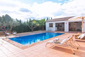 a villa with a swimming pool and a house at Finca Les Oliveres in Benissa