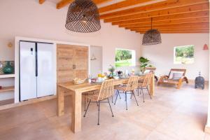 a kitchen and dining room with a wooden table and chairs at Finca Les Oliveres in Benissa