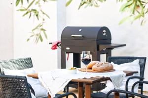 a bread maker on a table with a glass of wine at Finca Les Oliveres in Benissa