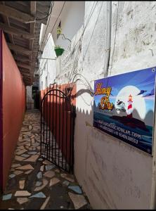 an alley with a sign on the side of a building at Honeybliss Homestay in Trivandrum