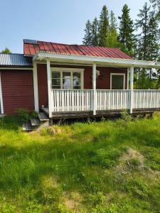 a small red house with a white porch at The Secret Cabin  +43 photos