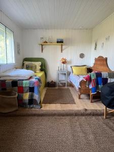 a room with two beds and a couch and a table at The Secret Cabin 