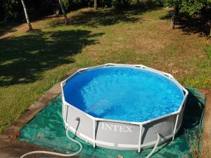 a large pool of water in a yard at Log cabin in Belgrade