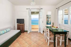 a bedroom with a bed and a table and a television at Villa Irida in Apraos