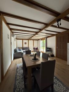 a dining room with a table and a couch at Vikendica Čardak in Srebrenik