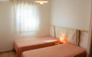 a small room with two beds and a window at Le Petit Etang in Gréoux-les-Bains +9 photos