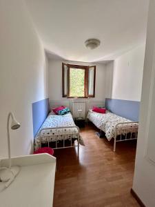 a room with two beds and a window at San Gemini Fiori in San Gemini