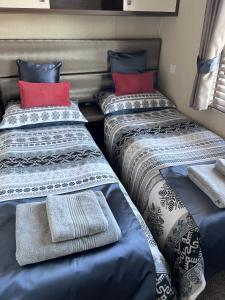 a group of three beds in a room at Drift Lodge in Tain