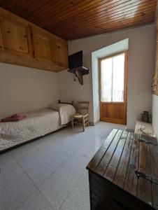 a bedroom with a bed and a wooden ceiling at LA CASETTA DI SILVIA in Villetta Barrea