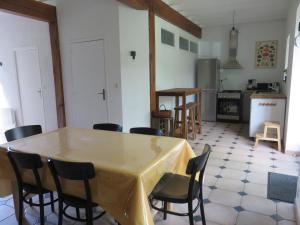 a kitchen with a table and chairs in a room at Le cellier d'halouze in Dol-de-Bretagne
