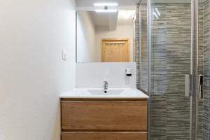 a bathroom with a sink and a shower at Terrasse avec vue sur les montagne pour 6 in La Joue du Loup +11 photos