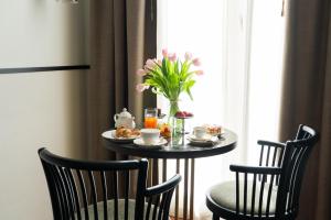 a breakfast table with a vase of flowers on it at Hotel Regina in Milan