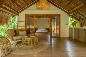 a living room with a couch and a table at Beachside Villa with Private Pool - Kalima Villas in Catangnan