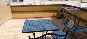 a table and two chairs on a balcony at appartamento celeste in Pantelleria