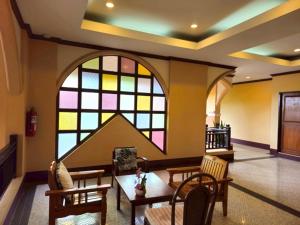 a room with a large stained glass window at Baan Lanna ChiangRai in Chiang Rai
