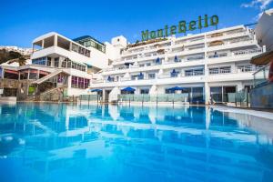 a hotel with a swimming pool in front of a building at Servatur Montebello in Puerto Rico de Gran Canaria