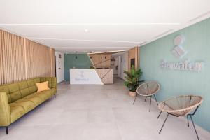 a lobby with a couch and chairs and a table at Servatur Hartaguna - Adults Only in Puerto Rico de Gran Canaria