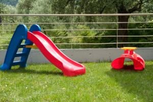 a playground with a slide in the grass at SK Suites Thassos in Skala Potamias