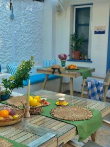 a table with fruits and candles on top of it at Pangea Sığacık Suite Hotel & Bistro in Seferihisar