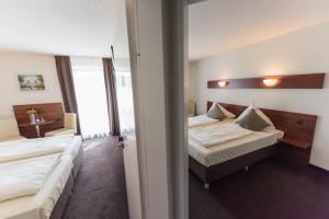 Postel nebo postele na pokoji v ubytování Hotel am Wall
