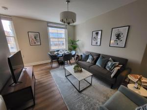 a living room with a couch and a table at 1 Bed Apartment Russell Square in London +2 photos
