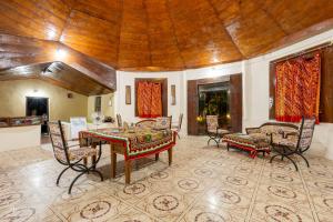 a dining room with a table and chairs in a room at Kutch Safari Resort in Kunria