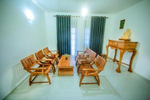 a room with chairs and a table and a piano at Villa Enchanté - Apartment in Nugegoda 2BR in Talapatpitiya