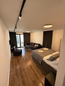 a large bedroom with a bed and a couch at Felicita Apartments in Sarajevo +13 photos