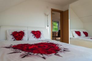 a bed with a bunch of red roses on it at Sunset Villa Apartments in Ohrid
