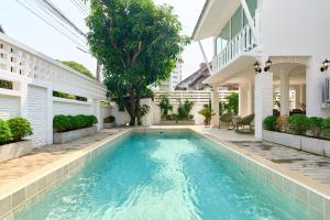 a swimming pool in the courtyard of a house at Luxury Pool Villa in the Heart of the Chiang Mai in Chiang Mai