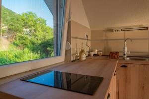 a kitchen with a window and a counter with a sink at Sunset Villa Apartments in Ohrid
