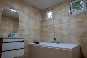 a bathroom with a tub and a sink at Sunset Villa Apartments in Ohrid +21 photos