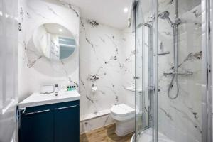 a bathroom with a shower and a toilet and a sink at Sea Cloud - 2-bedroom House with Courtyard Garden in Poole +25 photos
