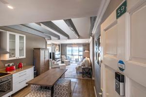 a kitchen and living room with a table in a room at Beach life in Summerstrand