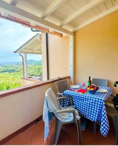 a table and chairs on the balcony of a house at Residence Le Solane in Marina di Campo