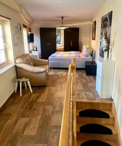 a living room with a couch and a bed at Ferienwohnung Stadtzauber in Malchow