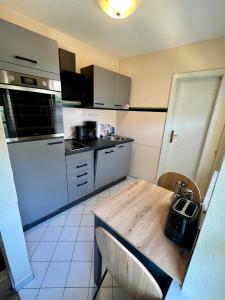 a kitchen with a wooden table and a counter top at Ferienwohnung Stadtzauber in Malchow
