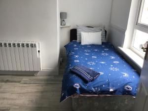 una camera da letto con un letto con un piumone blu di Divine Mercy B&B a Knock