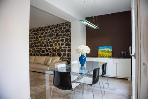 a dining room with a glass table and chairs at Villa Ginevra- Private Pool in Orosei