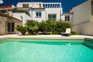 a swimming pool in front of a house at Villa Ginevra- Private Pool in Orosei
