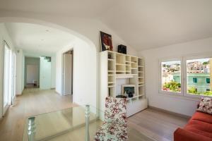a living room with a glass table and a couch at Villa Ginevra- Private Pool in Orosei